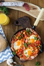 Baked eggs with sausage and vegetables in the pan. close up top view Royalty Free Stock Photo