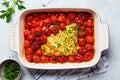 Baked feta cheese with tomatoes in dish. Trendy homemade recipe Royalty Free Stock Photo