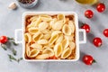 Baked feta pasta. Tomatoes drizzled with olive oil in a baking dish with a feta cheese block in the middle and sprinkled with salt Royalty Free Stock Photo