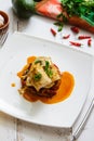 Baked fish in Basque, avocado and lemon top view. French cuisine