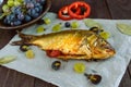 Baked fish carp, stuffed bell peppers and grapes Royalty Free Stock Photo