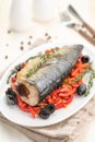 Baked fish mackerel with vegetables, sweet pepper and black olives and herbs Royalty Free Stock Photo