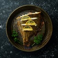 Baked flounder fish with lemon and spices on a metal baking dish. Seafood. Top view.