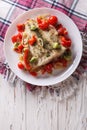 Baked flounder with seasonal vegetables. vertical top view