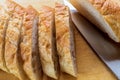 Pieces of Baguette Loaf of French Bread, on wooden board.