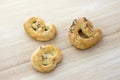 Baked fresh pretzels on wooden table, heart and twisted knot shapes, covered with poppy seeds salt and caraway seeds