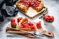 Baked galette with strawberry and rhubarb. Homemade pie, tarte. Gray background. Top view Royalty Free Stock Photo