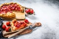 Baked galette with strawberry and rhubarb. Homemade pie, tarte. Gray background. Top view. Copy space Royalty Free Stock Photo
