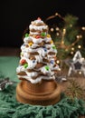 Baked gingerbread christmas tree on wooden background. Close-up