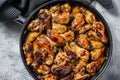 Baked glazed chicken wings in a pan. White background. Top view Royalty Free Stock Photo