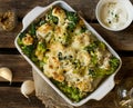 Baked gratin of cauliflower, broccoli and romanesco with cream and mustard sauce