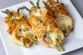 Baked green asparagus with ham and cheese in puff pastry sprinkled with sesame seeds Royalty Free Stock Photo