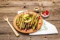 Baked green bean casserole topped with sesame seeds, pomegranate, mint and lemon Royalty Free Stock Photo