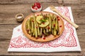 Baked green bean casserole topped with sesame seeds, pomegranate, mint and lemon Royalty Free Stock Photo