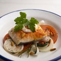 Baked hake cooked vegetables. Traditional northern Spanish recipe. Royalty Free Stock Photo