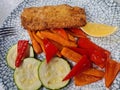 Baked hake fish in oven with vegetables on plate Royalty Free Stock Photo