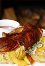 Baked half of duck with a potato, apples and pineapple Royalty Free Stock Photo
