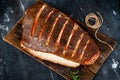 Baked halibut fish homemade on a wooden Board on a dark background, seafood hot smoked Royalty Free Stock Photo