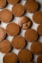 Baked halves of brown macaroons are neatly laid out in several rows Royalty Free Stock Photo
