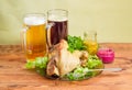 Baked ham hock with condiments, lager beer and dark beer Royalty Free Stock Photo