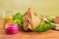 Baked ham hock with fork and condiments closeup Royalty Free Stock Photo