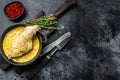 Baked hare Haunches in Pan with Stewed Vegetables. Black background. Top view. Copy space