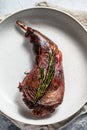 Baked hare leg with herbs, served on textile napkin. Organic meat. Top view