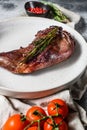 Baked hare leg with herbs, served on textile napkin. Organic meat. Top view