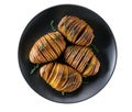 Baked hasselback potato in a black plate isolated on white background Royalty Free Stock Photo