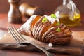 Baked hasselback potato with sour cream Royalty Free Stock Photo