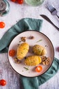 Baked hasselback potatoes with garlic and rosemary on a plate. Homemade lunch. Top and vertical view Royalty Free Stock Photo