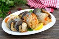 Baked herring stuffed with vegetables. Tasty fish rolls Royalty Free Stock Photo