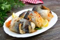 Baked herring stuffed with vegetables. Tasty fish rolls Royalty Free Stock Photo