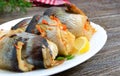 Baked herring stuffed with vegetables. Tasty fish rolls. Close up Royalty Free Stock Photo