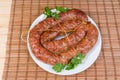 Baked homemade pork sausage curtailed by the rings on dish Royalty Free Stock Photo