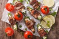 Baked Jalapeno pepper with feta cheese wrapped in bacon close-up on the table. Horizontal top view