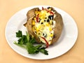 Baked kumpir potato stuffed with cheese, sausage, olives, pepper