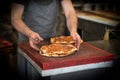 Baked lahmacun is a round, thin piece of dough topped with minced meat most commonly beef or lamb, minced vegetables and herbs.