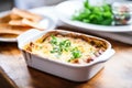 baked lasagna in a dish with bubbling cheese