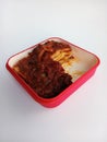 Baked lasagne in a red casserole dish isolated on a white background Royalty Free Stock Photo