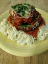 Baked and Layered Eggplant Parmesan Served atop Angel Hair Pasta Royalty Free Stock Photo