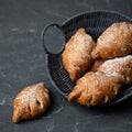 Baked leaf-shaped buns in basket on gray background. Fresh pastries food for breakfast concept. Square format or 1x1 for