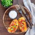 Baked loaded potato skins with cheddar cheese and bacon, garnish