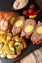 Baked meat loaf wrapped in bacon stuffed with egg and served wit Royalty Free Stock Photo