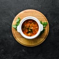 Baked meat with potatoes and vegetables in a bowl. Ukrainian traditional cuisine. Top view. Royalty Free Stock Photo