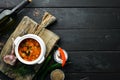 Baked meat with potatoes and vegetables in a bowl. Ukrainian traditional cuisine. Top view. Royalty Free Stock Photo