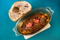 Baked meatloaf with bacon, onion and kumquat in glass pan, bread