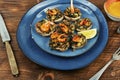 A plate of baked mushroom caps and shrimp