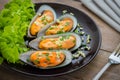 Baked mussels with garlic on plate