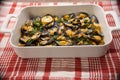 Baked mussels in a spicy sauce in a white gratin dish Royalty Free Stock Photo